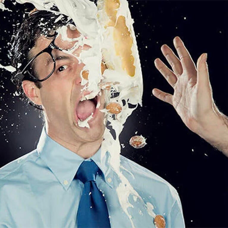 A business man gets pied in the face