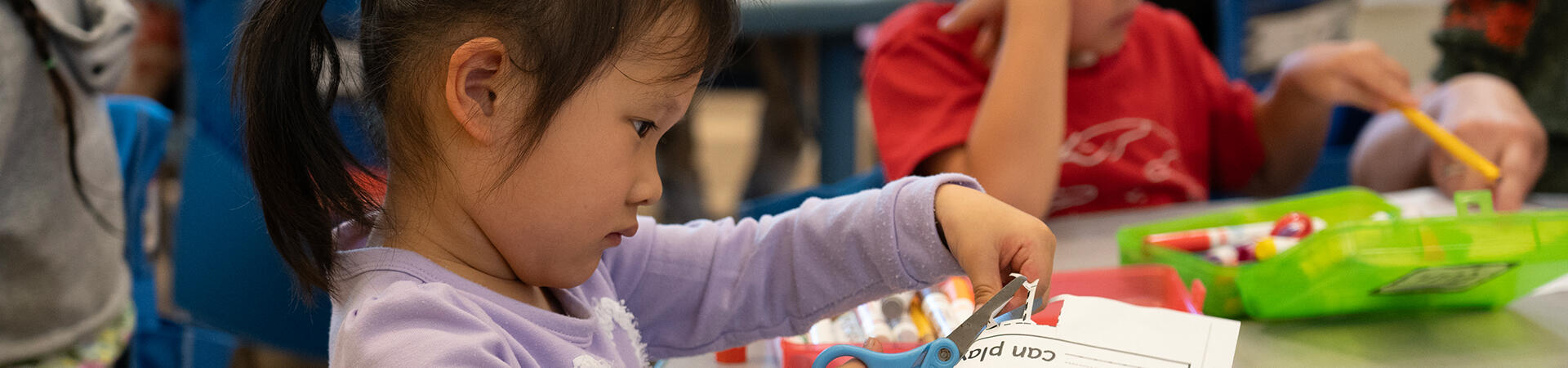 child cutting paper