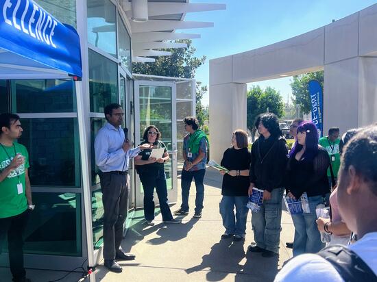 Students gather outside CE-CERT’s main entrance, listening to an introduction during the STEPCon 2024 high school tour event.
