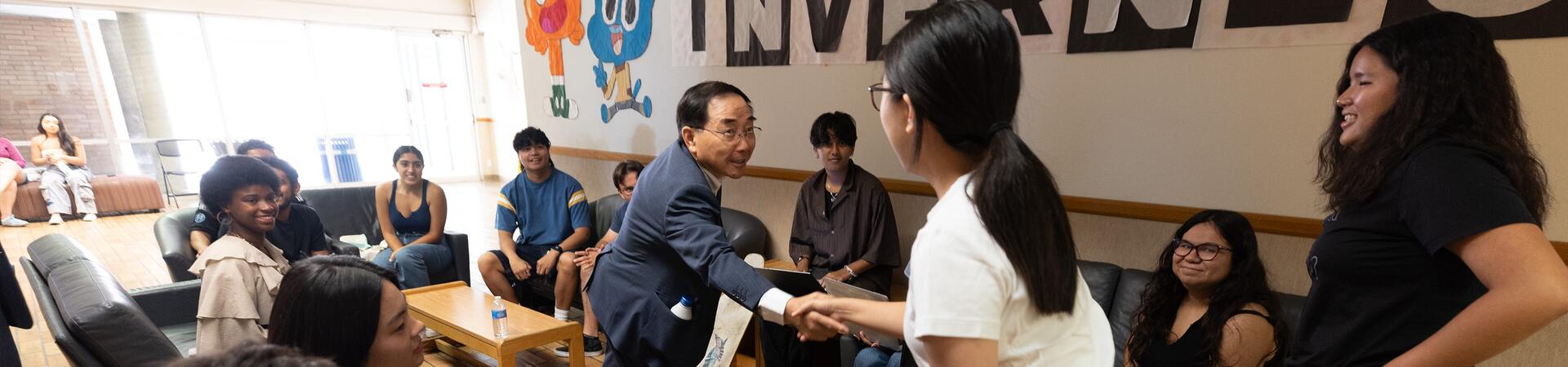 Chancellor S. Jack Hu, makes his way around shaking the hand of every student who are Assistant Resident Directors