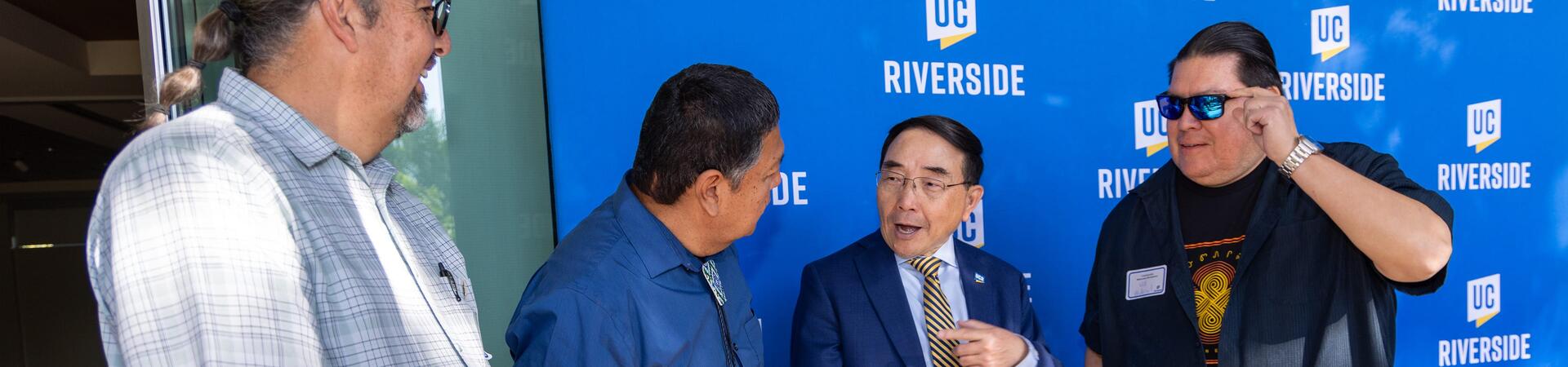 Chancellor S. Jack Hu speaking with staff at Community reception event
