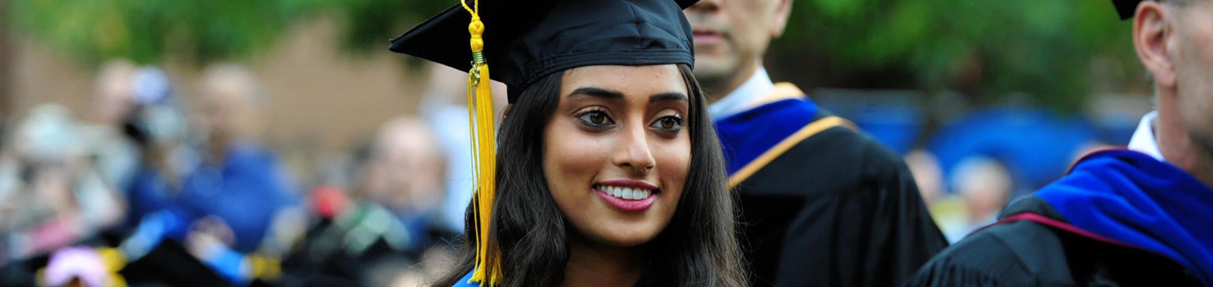 graduate wearing cap and gown