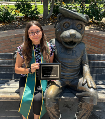 CNAS student sitting by Scotty statue