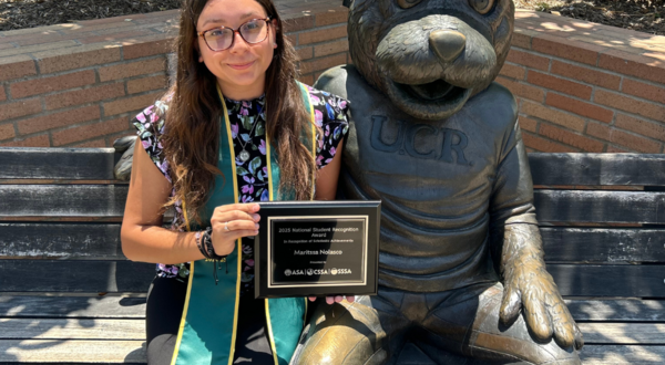 CNAS student sitting by Scotty statue