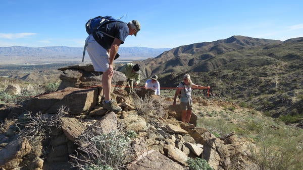 man on a mountain with a backback (c) UCR
