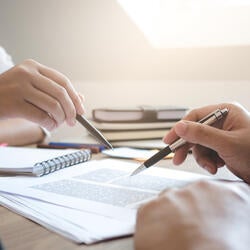 Two people studying with books