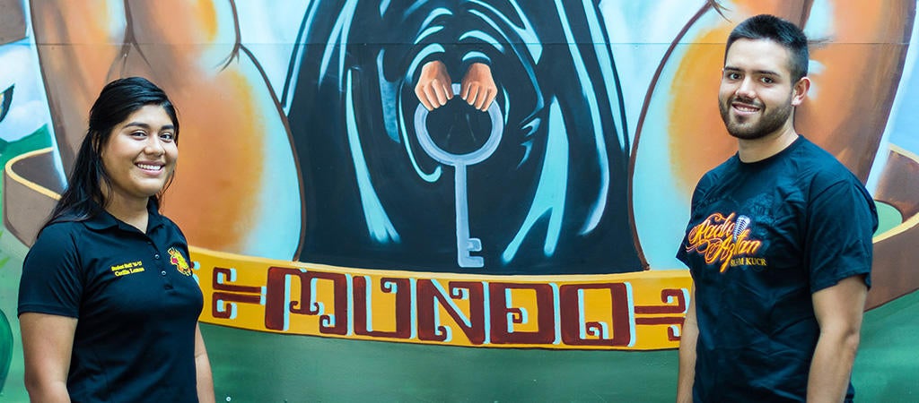 Two CSP students standing in front of the Mundo Chicano/Latino Theme Hall