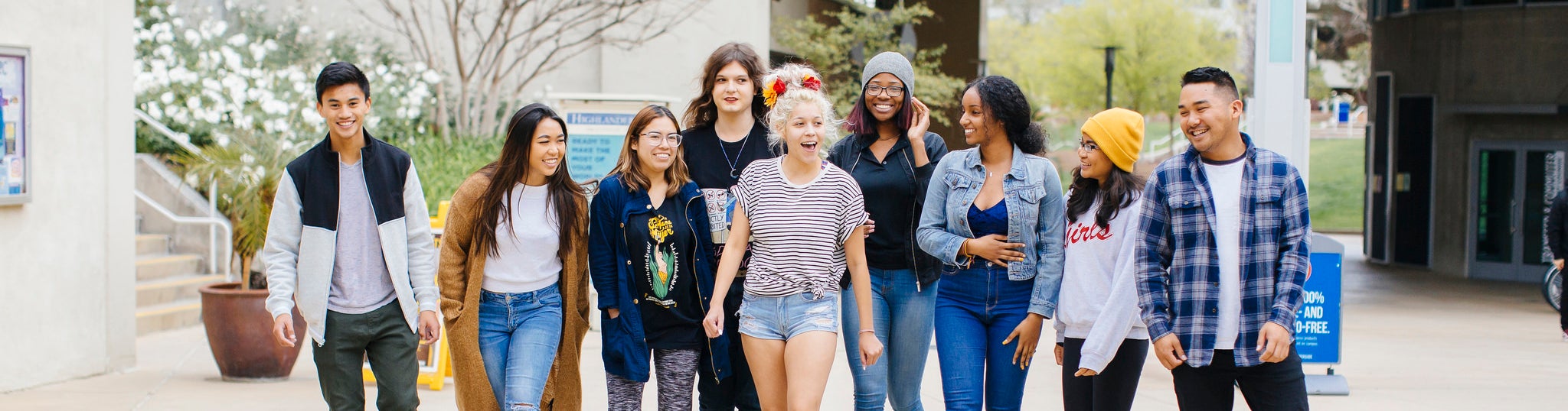 UCR students of various ethnicities, genders and backgrounds walk together across the UCR campus.