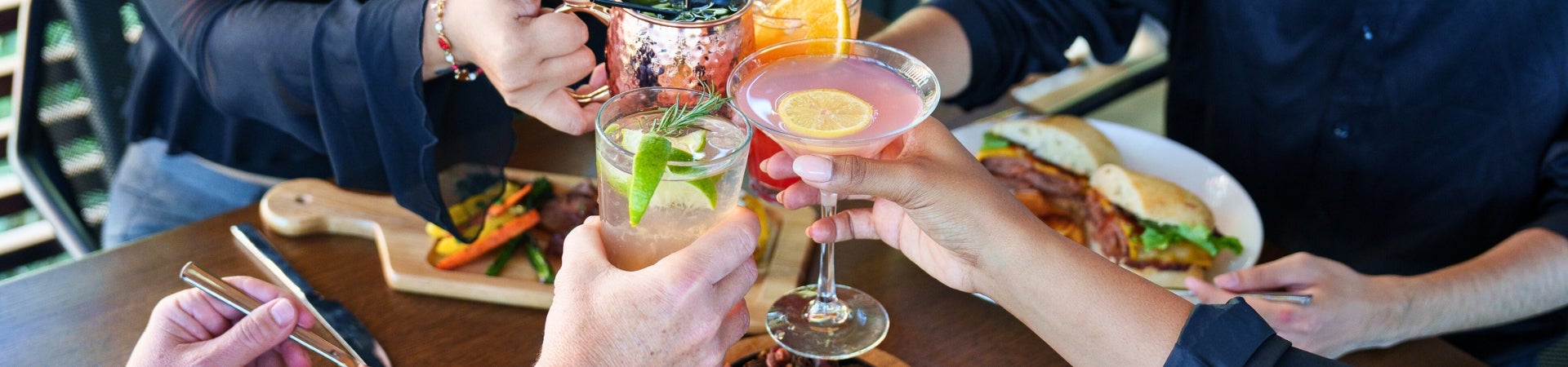 People in the stable with drinks in hand doing cheers