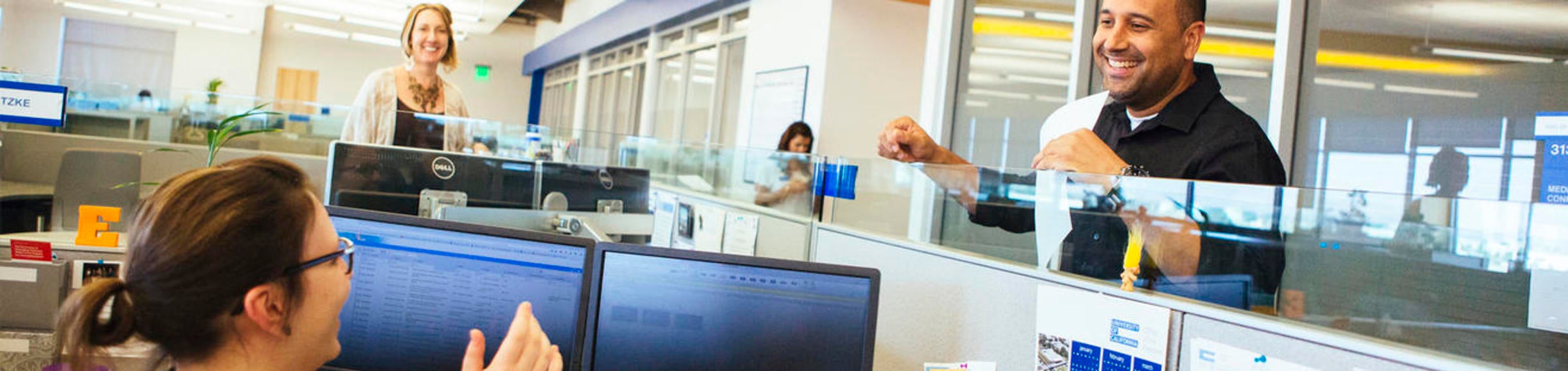 Staff members working and talking