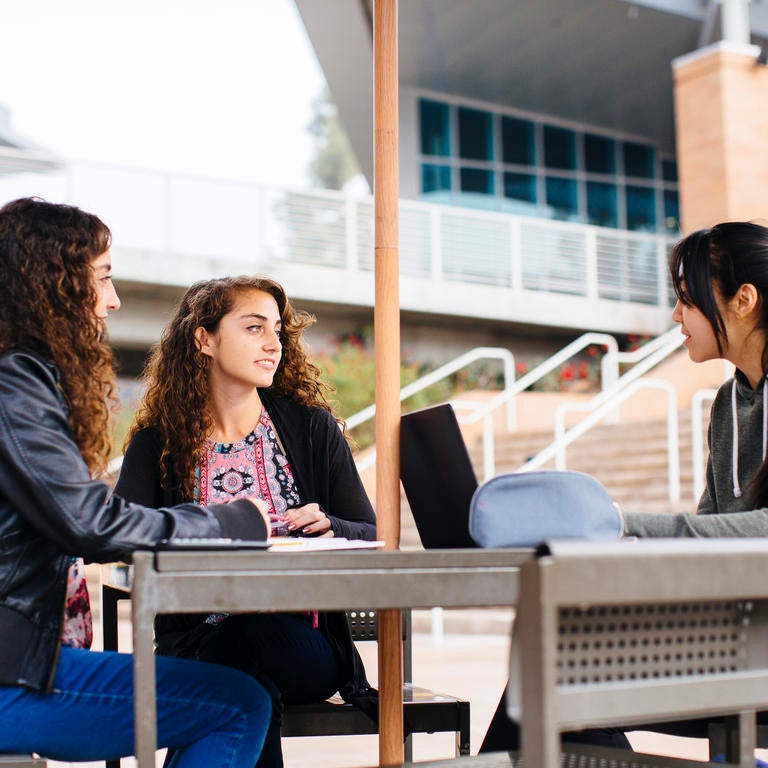 Students working together at a table at the HUB