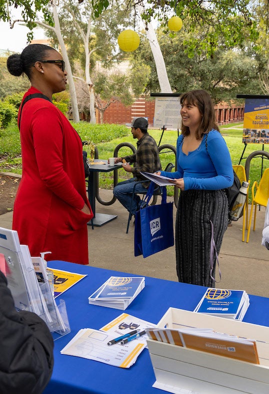 Student speaking with Dr. Raquel Rall