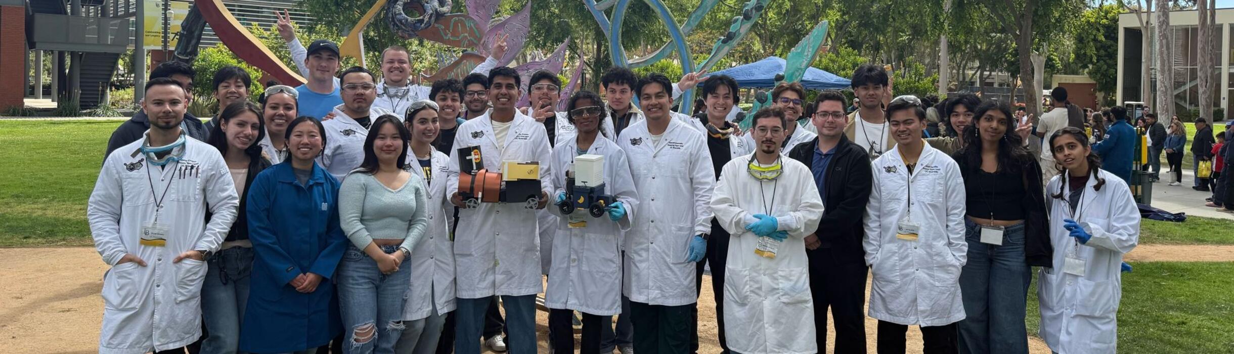 members of AIChE posing together with their project wearing PPE