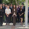 men and women members of Tau Beta Pi posing outdoors most wearing business attire