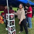 Theta Tau student standing by a BCOE decoration