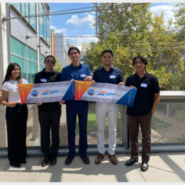 five students holding an ATP bio sign on the Bourns Bridge