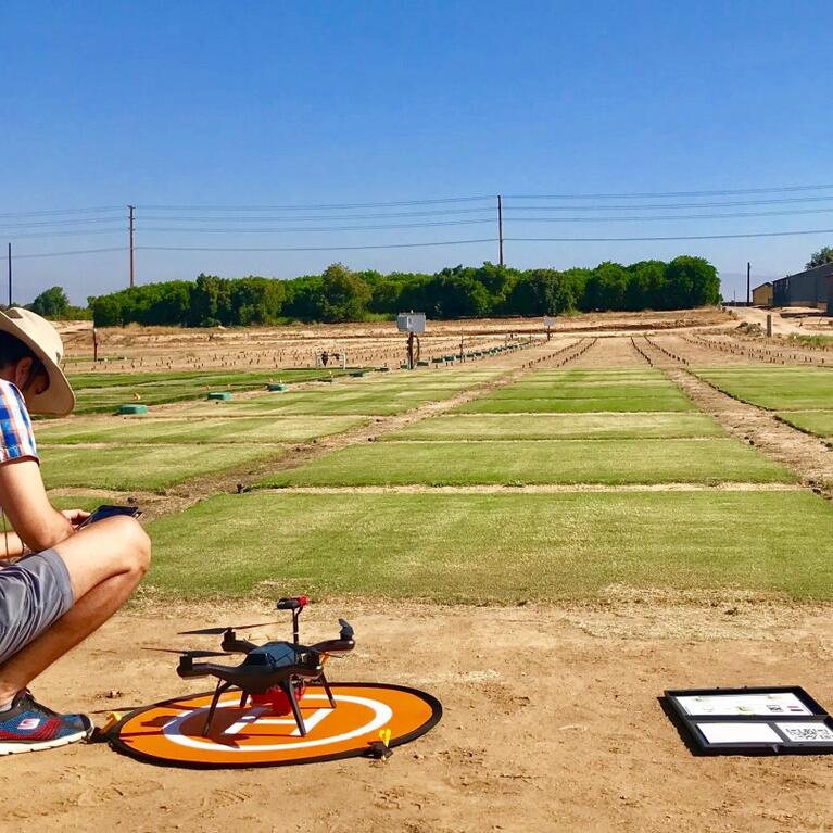 Person with drone overlooking field 