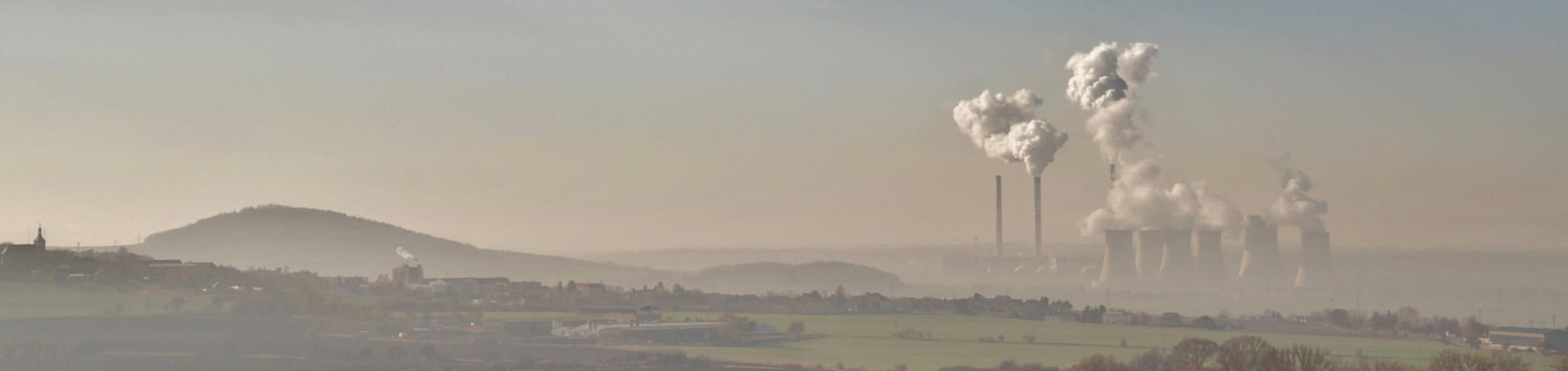 Smokestacks against a hazy landscape