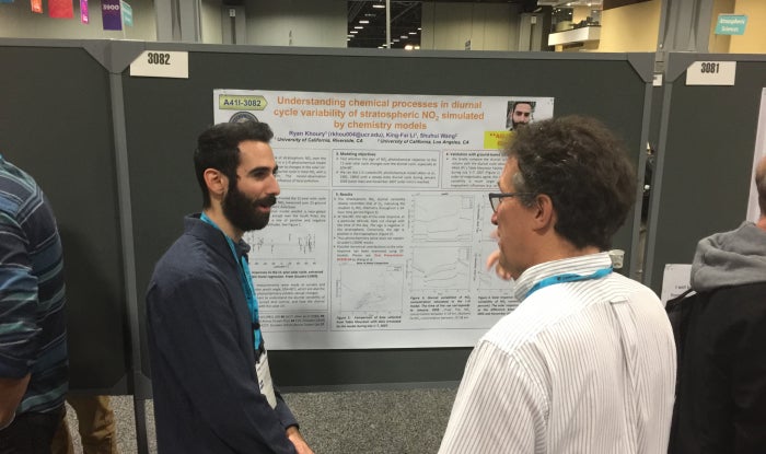 Undergraduate student presenting poster at conference.