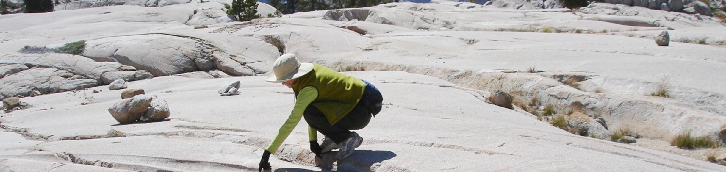 Person looking at rock formations of a subglacial river.