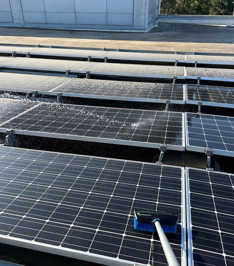 Handle brush cleaning solar panels