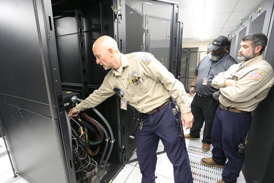 Electricians examining cables