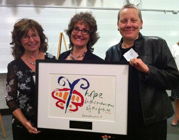 3 women holding an award plaque