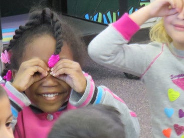 group of students making binoculars with their hands in front of their faces