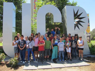 children at the UCR sign