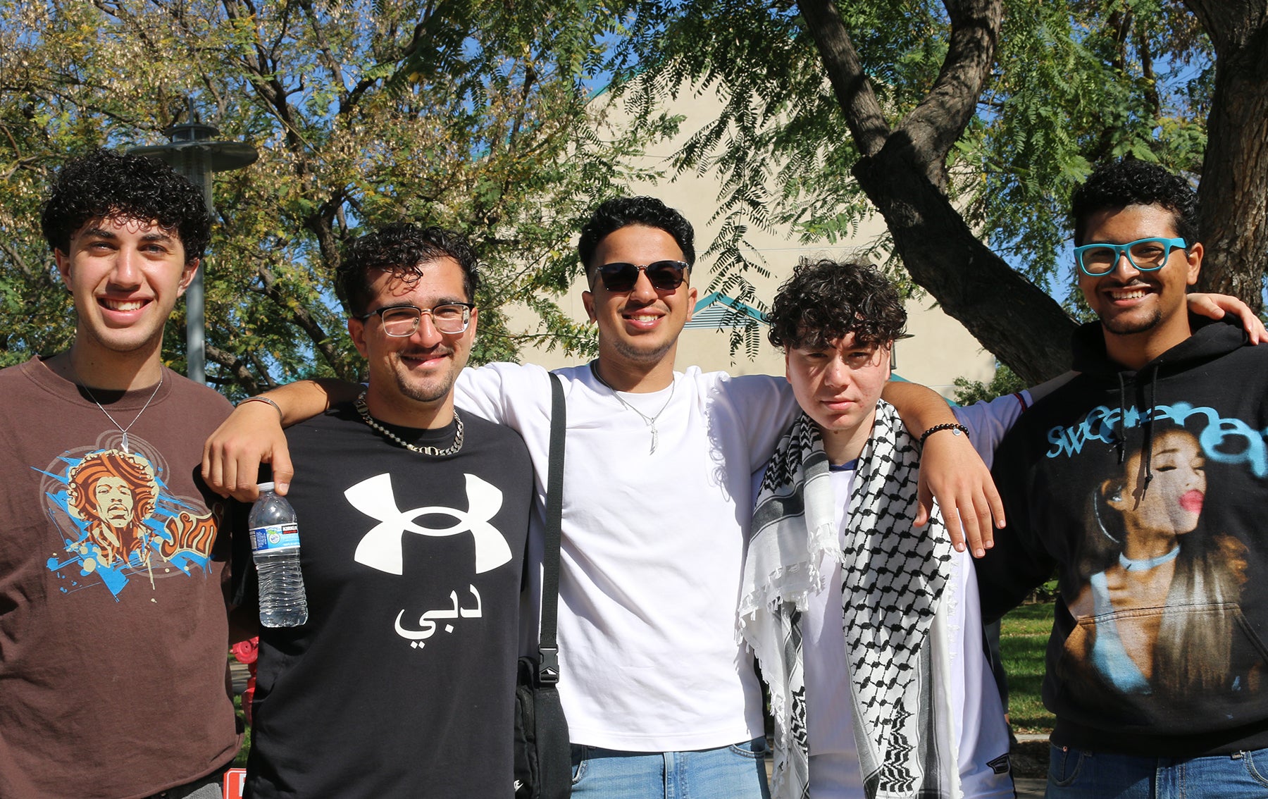 five students arms around each other