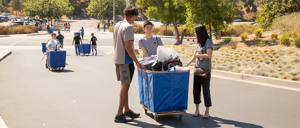 Students pushing moving cart