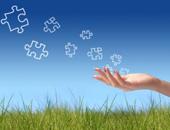 Puzzle pieces blowing away in wind