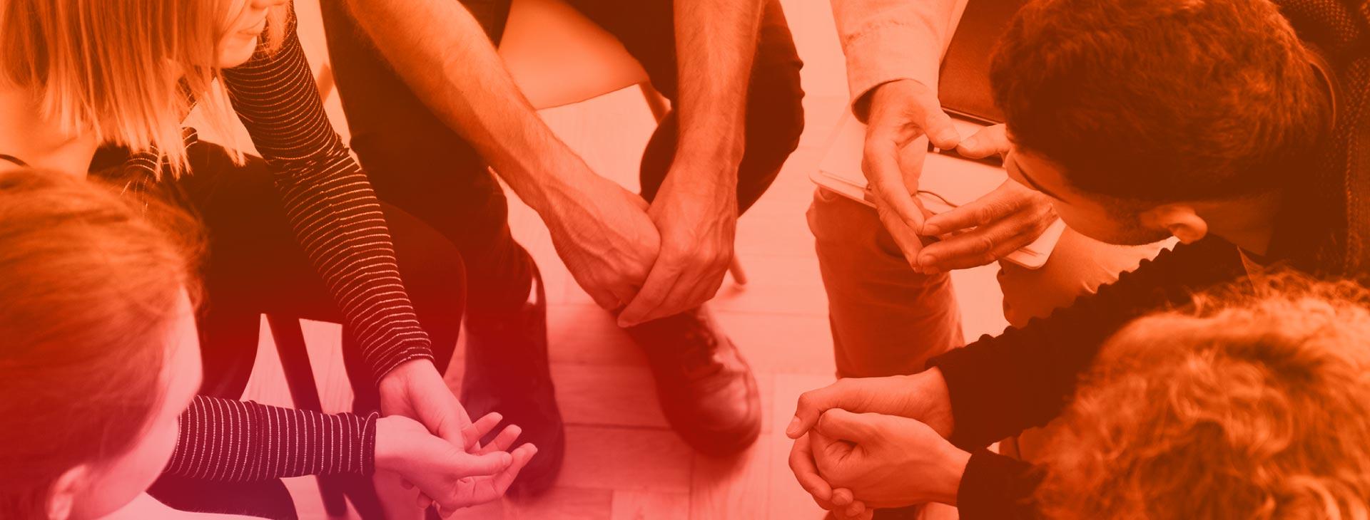 Duotone of Students sitting in a circle during a group session.