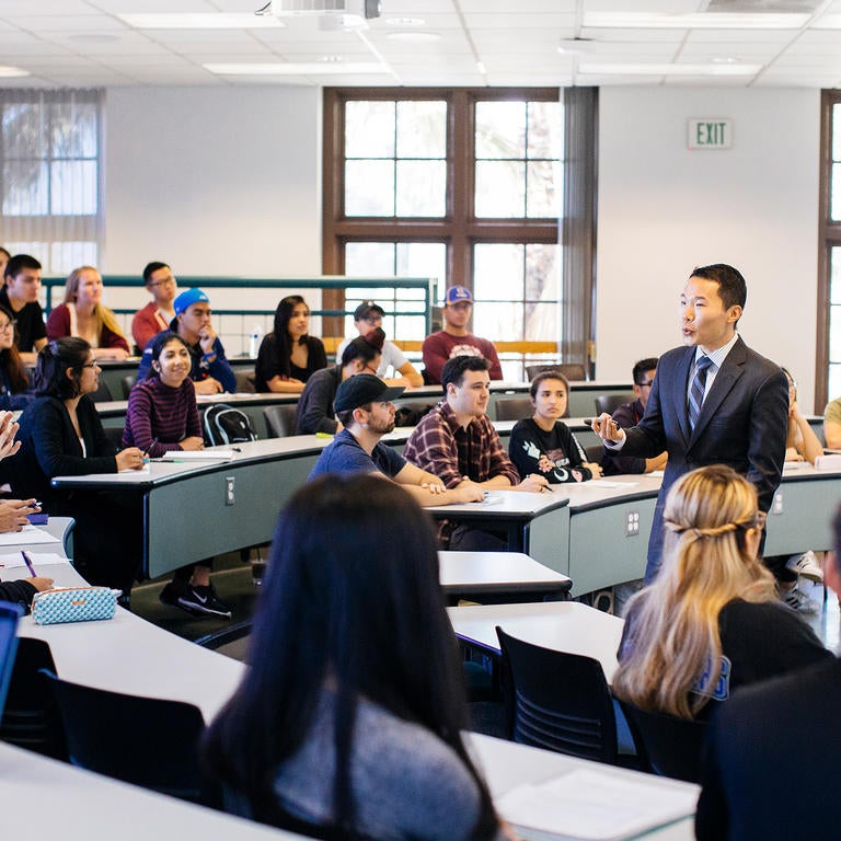 UCR faculty lecturing to class in business building