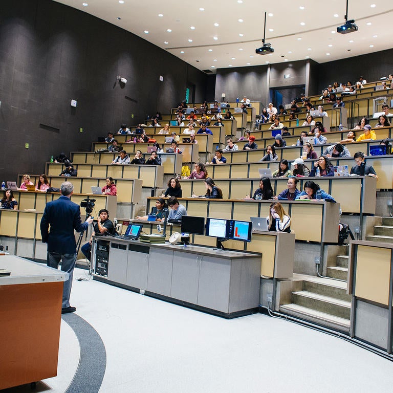 UCR faculty lecturing to class in Physics auditorium