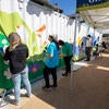Volunteers help paint a 40-foot-long mural on Tuesday, Oct. 3, 2023 at R'Garden. (UCR/Stan Lim)