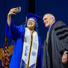 Business graduate taking selfie with Chancellor Wilcox