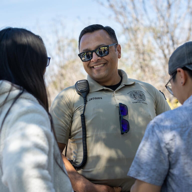 Campus safety responder Oscar Jacques with two students