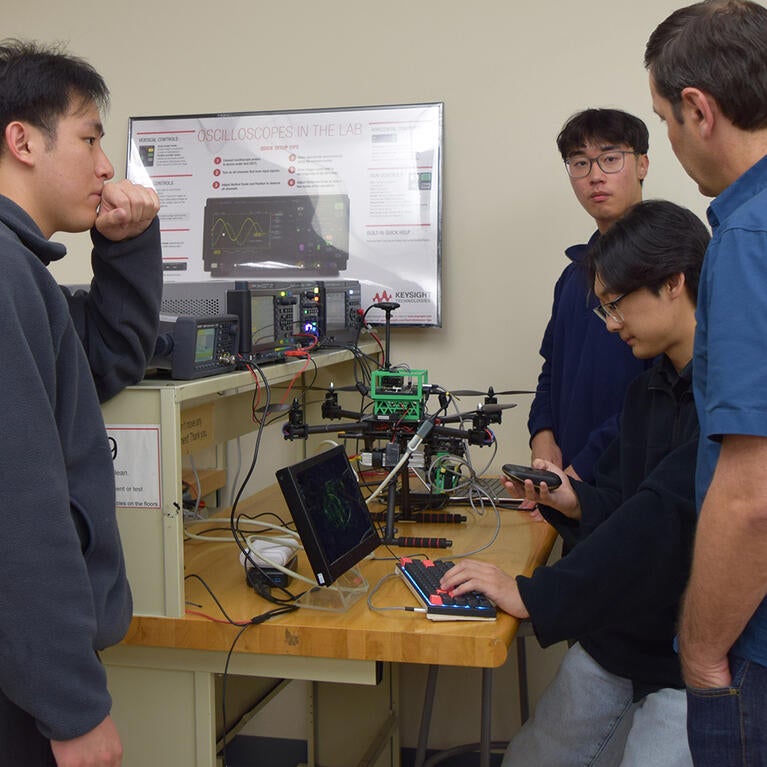 Engineering students work with equipment