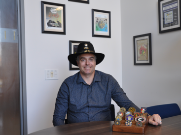 Scott Pegan with challenge coins and Stetson