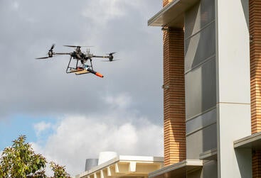 Drone leaf blower next to Pierce Hall