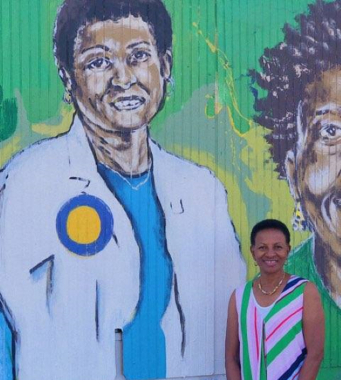 Deas in front of mural