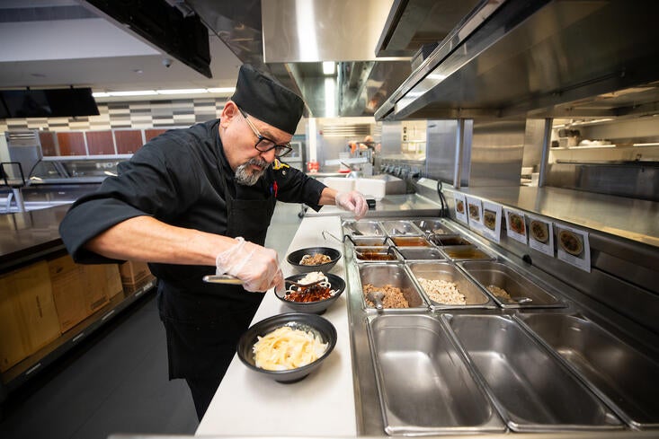 chef prepares noodles