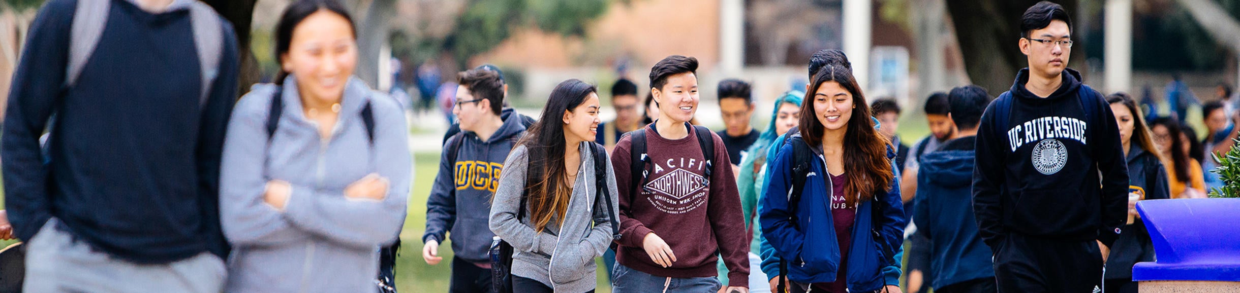 Group of UCR students walking near HUB