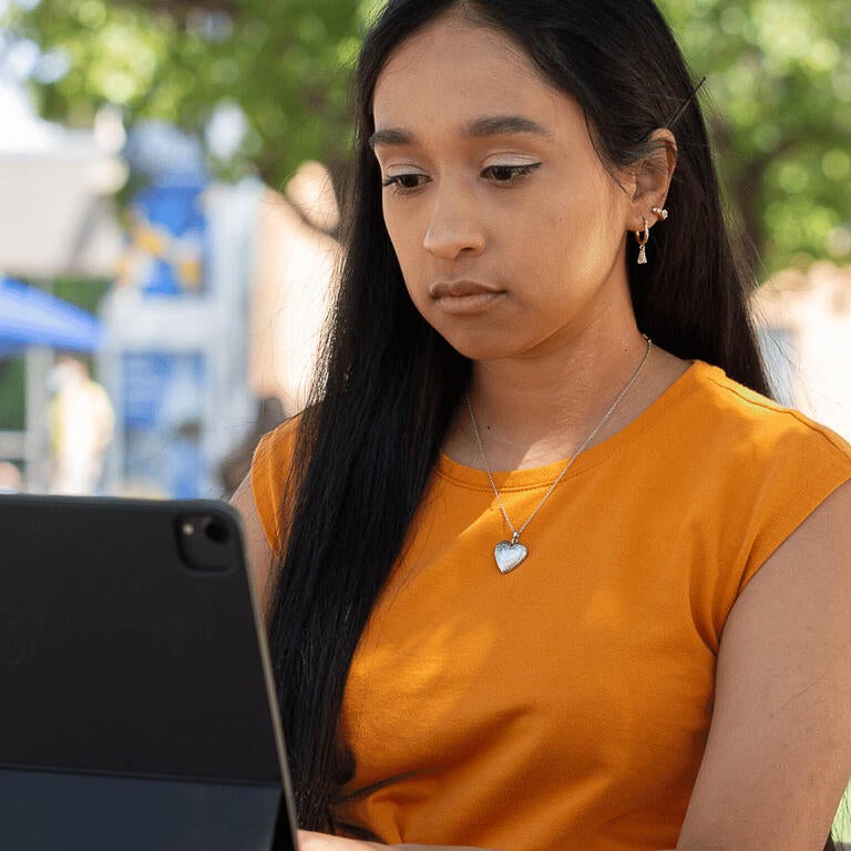 Woman sitting with laptop