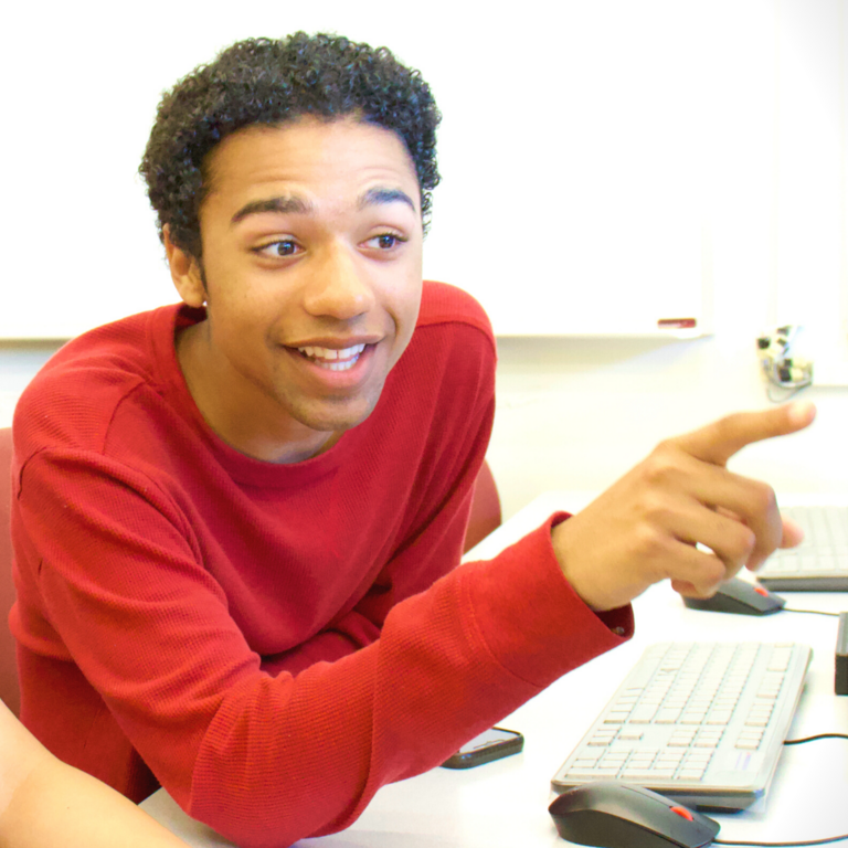 Excited student points at computer monitor