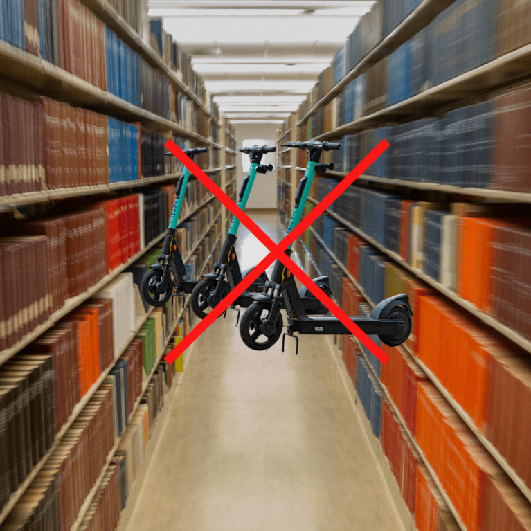 Image of library aisle. Scooters in middle of the aisle with a red x. 