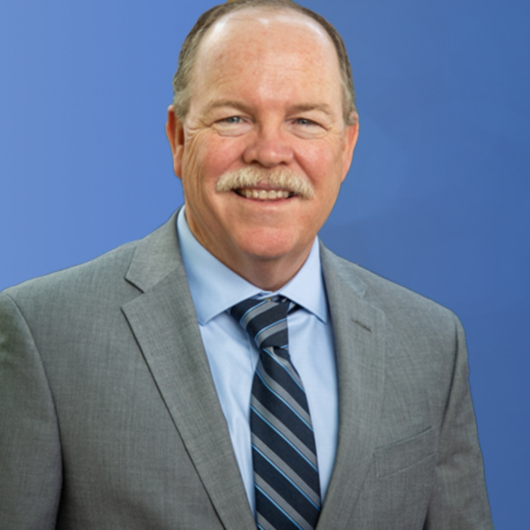 Tim Collins in front of a globe