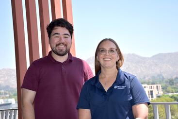 Brian Blackburn and Kate Dorff standing next to each other on the terrace in the SOM Ed II building