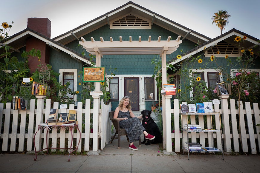 Susan Straight sitting outside home with dog, Angel.